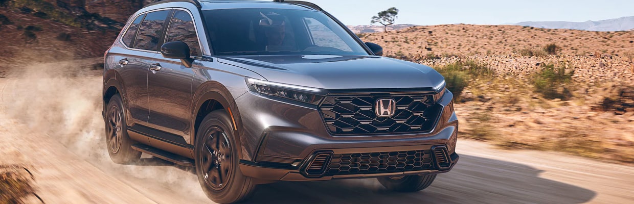 Gray Honda CR-V Hybrid driving in the desert