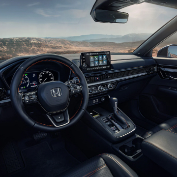 Interior shot of entire front dashboard from over drivers left shoulder perspective