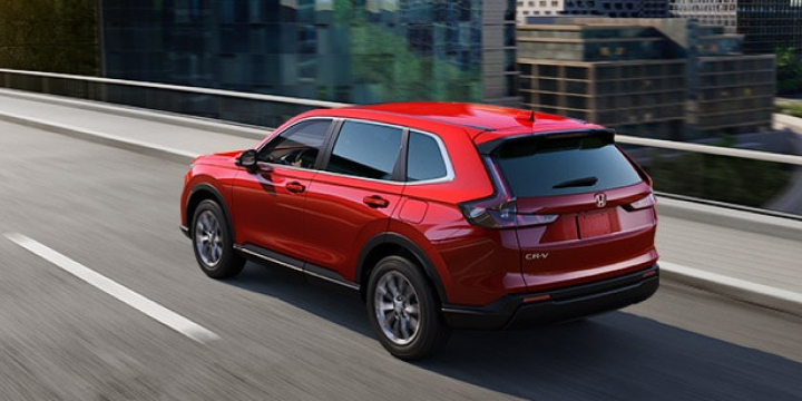 Rear right quarter overhead shot of red CR-V driving along elevated city highway