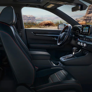 Interior shot of dashboard and seats from passenger waist level perspective