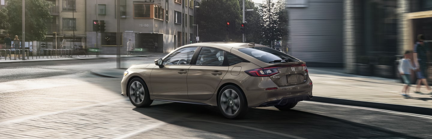 2025 Honda Civic Hatchback Hybrid driving in the city