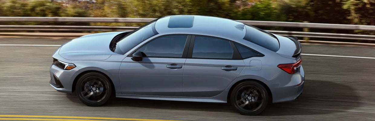 Silver Honda Civic Si driving down highway