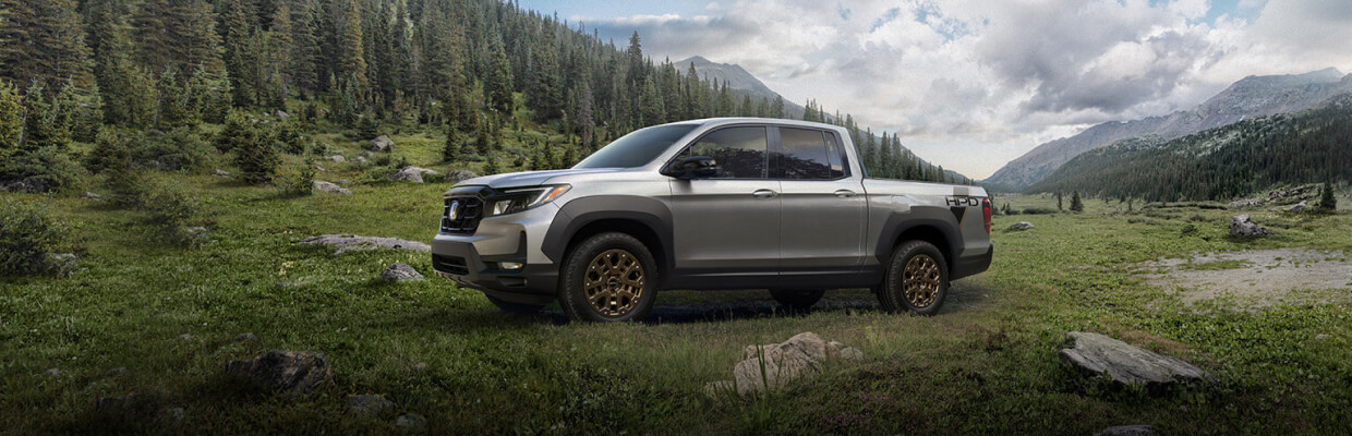 Honda Ridgeline parked by mountain