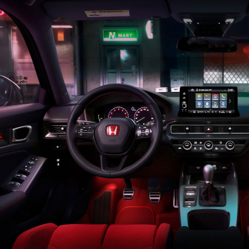 Interior shot of steering wheel, gear shift and otherwise driver only instruments