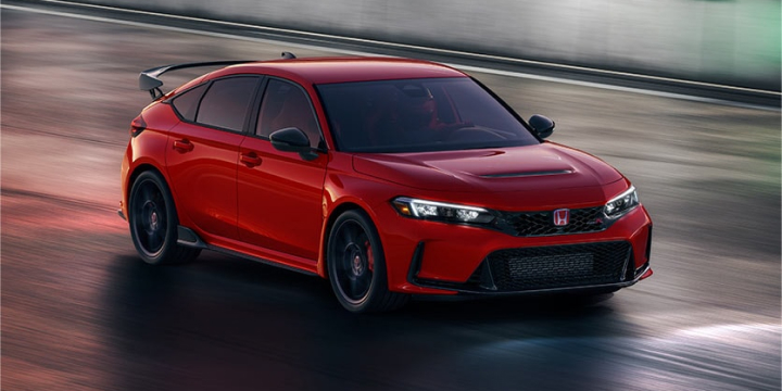 A red left facing Civic Type R drive by close-up shot