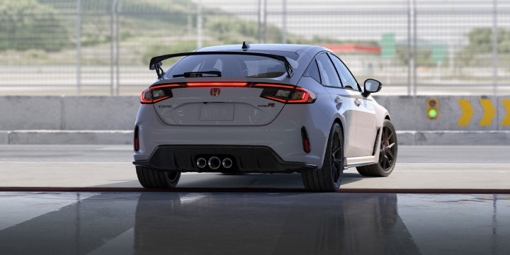 Rear shot of civic type r leaving garage bay of a track